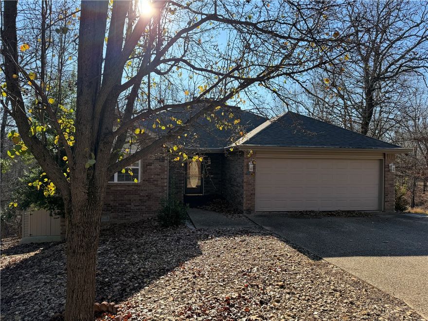 Priced below appraised value. The seller is offering a concession of up to $6,000 toward the required sewer connection expense. Tucked away on a quiet cul-de-sac, this warm and inviting home offers the privacy, space, and wooded setting Bella Vista buyers love. With 3 bedrooms, 3 full baths, this property provides a comfortable layout with room to spread out. The main level features a bright living area with a cozy wood stove, an open dining space, and a well-appointed kitchen with abundant cabinets and counter space. The wooded 0.46-acre lot enhances the peaceful setting. Located minutes from trails, lakes, golf, and all Bella Vista amenities, this home combines seclusion with convenience. A great opportunity to own a well-cared-for property in a beautiful natural setting.