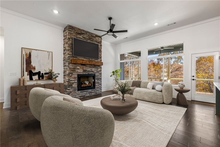 Construction is complete! Make this new build by Elite Thomas Homes your next home. Conveniently located on Bella Vista’s east side just off Lancashire/340 and less than a mile from the Back 40 Trailhead, this home offers a perfect blend of traditional design and natural surroundings.
Inside, you’ll find 3 bedrooms, 2 bathrooms, a dedicated office, and an oversized 2-car garage. The main living area features 11’ ceilings, a stacked-stone vent-free gas fireplace, and hardwood floors throughout the entry, living room, hallway, and primary suite. The primary suite includes a luxurious bathroom with a dual vanity and a spacious tiled shower with dual shower heads.
The two additional bedrooms and the office feature plush carpeting for comfort. The back deck overlooks wooded common property—no neighbors behind you, and both side lots are currently vacant.