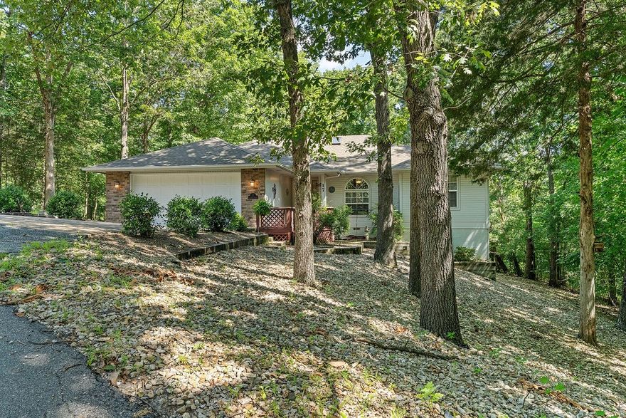 Charming 2 bedroom 2 bath home nestled among mature trees,offering privacy and peaceful setting. This well maintained property features an open living area and a gas fireplace for all those chilly winter nights. An amazing sunroom to enjoy your morning coffee great for 3 season tv room. Enjoy natures views from every window and relax on the shaded deck. A perfect blend of comfort and seclusion- ideal for everyday living or a quiet retreat. HVAC is new in 2025,roof is only about 10 years old and the hot water heater was replaced recently. Home features a large office with built in cabinets for all your office needs. Basement has a great workshop area with double door access and has windows with natural lighting. Large family room! 3\4 inch solid oak flooring with easy maintenance. Vaulted ceilings,cable and fans in most all rooms. 2 car garage with a storeroom, pull down attic access and storage. Kitchen table area for your dinning needs. Very convenient to all of NWA. Very private setting!!!