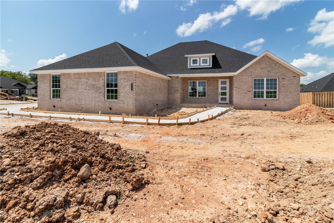 Step into effortless elegance with this stunning 2,647 sq ft one-level home designed for modern living and timeless style. The open, split floor plan offers the perfect blend of space and privacy, ideal for both entertaining and everyday comfort. The gourmet eat-in kitchen is a chef’s dream, featuring gleaming stainless steel appliances, a gas cooktop, and ample counter space. The formal dining room is perfect for hosting unforgettable dinners. Rich hardwood floors grace the main living areas, while plush carpet adds cozy warmth to the bedrooms. Gather around the gas fireplace in the inviting living room with built in cabinets and floating shelving, energy-efficient Low-E windows that bathe the space in natural light. The spacious side-load 3-car garage provides both function and curb appeal. Every detail in this home is crafted for style, comfort, and efficiency—and with a 1-year builder’s warranty, peace of mind comes standard. This is more than a home—it’s the lifestyle upgrade you’ve been waiting for.