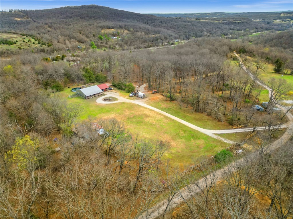 $10,000 Seller Credit Available! With an acceptable offer, seller will contribute $10,000 toward closing costs, lender fees, rate buy-down, or other eligible expensesāmaking your path to homeownership even smoother. Set on 16 acres of serene Arkansas countryside, this rustic 1,920 sqft home offers a retreat for outdoor enthusiasts seeking tranquility without sacrificing convenience. Just 20 minutes from town, it features 4 cleared acres and 12 wooded acresāideal for exploration, gardening, or simply enjoying nature. Built in 2014, it boasts 4 versatile rooms, including a master suite with walk-in closet and private bath. The open floor plan connects the family room, warmed by a cozy wood stove, to the dining area and spacious kitchen with pantry. Extras include a covered front porch, 32x30 attached carport with storage, and unfinished attic. Outdoor living is enhanced by gardens, a fire pit, horseshoe game area, and 100+ yard shooting lane.
