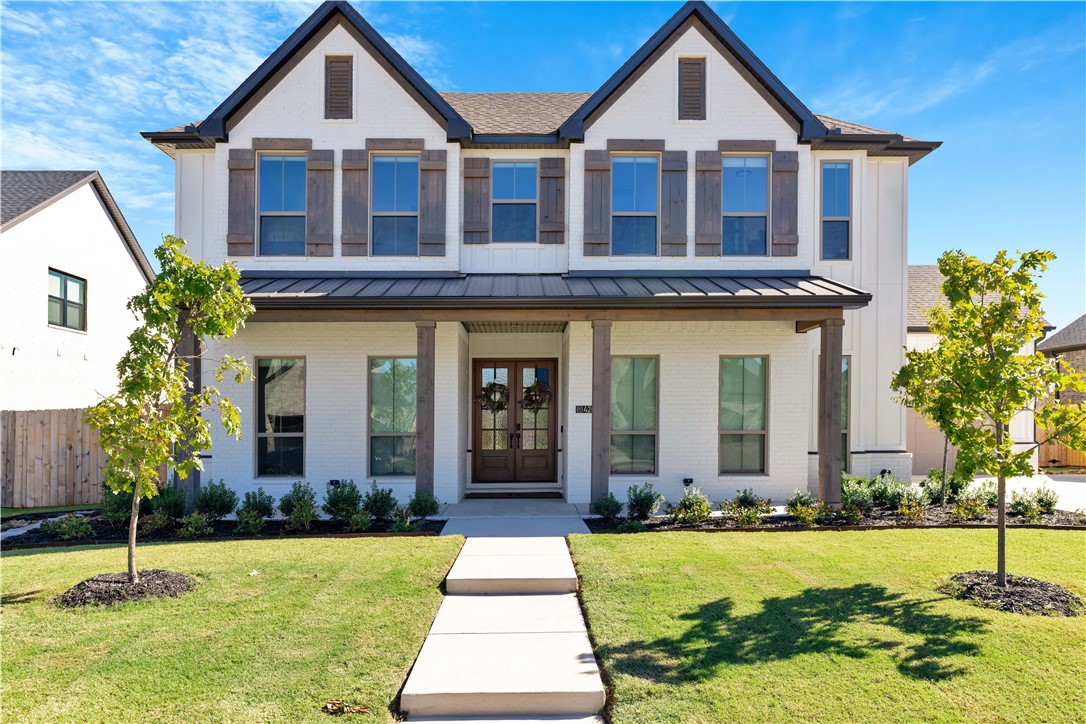 Welcome home to this Modern Farmhouse design w/spacious, open floor plan that is perfect for everyday living as well as entertaining. The living room is flanked by expansive windows & centered by the gorgeous fireplace. Kitchen is stunning w/amazing painted cabinets, wood trimmed vented hood & accented by gold hardware. Lg island w/farmhouse sink has ample work center. Roomy primary bedroom has large walk-in closet. Primary bath has separate vanities w/makeup area, deep vessel tub & separate W-I shower. Second bedroom on main floor has access to Hollywood bath.  Upstairs is a generous bonus area, 2 bedrooms & 2 bathrooms. Awesome outdoor patio w/vaulted, beamed ceiling & gas fireplace for owner’s enjoyment! Tankless water heater, Aqua Sauna filtration system, epoxy floors in garages & even an outside pad for trash cans. KIT fridge, washer & dryer convey. Neighborhood features a playground, community pool w/pool house, picnic area, and coming soon- a dog park! Completed in summer of 2025, this is a must-see home!