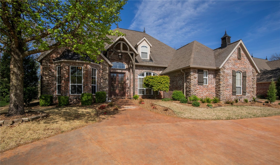 Dream home in the heart of Rogers! Nestled in one of the most sought-after locations, this exquisite residence offers the perfect blend of luxury, comfort, and convenience. Upon entering, you're greeted by the timeless elegance of a curved stairway and Brazilian Cherry hardwood floors throughout the main floor. Enjoy a dedicated office space with fireplace, french doors and built in shelving. The gourmet kitchen is equipped with stainless steel appliances, granite countertops & ample custom cabinetry. Entertaining guests is easy with the nice flow between kitchen, dining area & living space. Retreat to the main floor primary bedroom, featuring a luxurious ensuite & oversized closet plus private sun porch. Three upstairs bedrooms each have a private bathroom. The versatile bonus room has flexibility for additional living space. The three-car side load garage is oversized and provides plenty of room for vehicles and storage. Relax in the private backyard with a deck amidst the trees & large patio for entertaining.