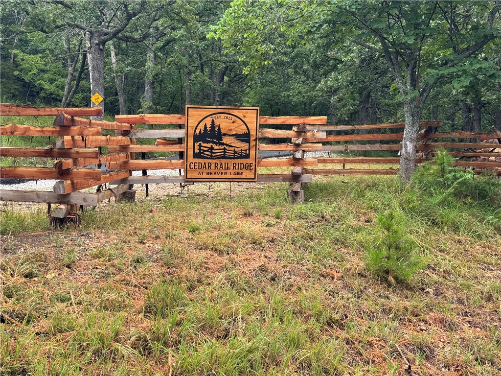 Entrance through the Cedar Split Rail Fence on either side of the road to this Beautiful Lake View 3.33 Acre lot. Stunning year-round views of Moulder Hollow on Beaver Lake in the Whispering Hills community. The lot has a level build site location over looking the lake, literally a blank canvas for you to dream it and make it your own. Buyer will need to drill a water well and install the septic system. This property features unmatched picturesque views, and there are plenty of options for homesites. Schedule your appointment today to see this Beautiful Lake View Property!