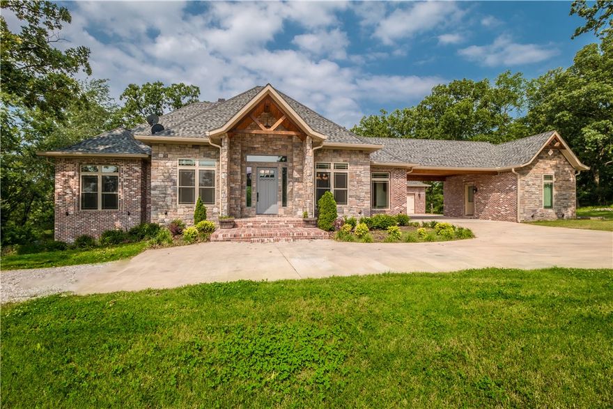 Picturesque gated estate situated on 11 private & serene acres. This beautiful 5 bdrm home is adorn w/quality finishes & open floor plan offering perfect setting for entertaining & tranquil countryside views from every room.  Main level includes study, formal dining rm, grandiose family rm w/reclaimed beams, gourmet kitchen, guest room w/en-suite and impressive master retreat w/exquisite bath & spacious walk in closet.  Additional features include hardwood floors, 2 stacked stone fireplaces, vaulted ceiling, and floor to ceiling windows for an abundance of natural light.  The lower level boasts a 2nd living area w/wet bar, bonus room, 2nd laundry rm, 3 guests rooms, storm shelter and incredible walk-in storage.  Magnificent barn built w/reclaimed wood includes 2400 sf shop/garage space & 1200 sf heated/cooled guest quarters. ALL NEW CARPET & PAINT!