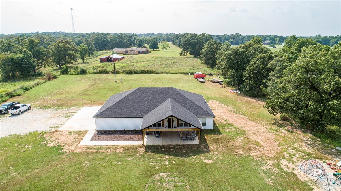 Don't miss out on this custom Country Living property close to Bentonville. 4.03 private acres! (near the new Bella Vista BY-PASS). Home has split 4 bed/2 full baths and open concept floor plan. Quartz counter tops & window sills. Kitchen has plenty of storage, soft close hinges and large center island w/a bottle washer, for easy entertaining . Butler's/ Pantry is a must see! Enjoy the ship lap feature in the bathrooms adding character with soaker tub to relax in. Enjoy the 20X32 FT COVERED front porch to relax quietly after a long day! 9 foot wall's and a custom 8 ft front door to welcome friends and family. Tankless water heater. 1200 sq ft 4-5 car garage for storage w/ cedar lined wall's! Large Master walk-in closet w/ built-in's! Upgraded insulation! Enjoy your huge living room that features a cedar mantle & vaulted ceiling! Upgraded 8 lb carpet pad in the bedrooms. Laundry room w/ large storage area. AT&T internet available. Looking for country living close to Bentonville then this is a must see!