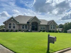 GOLF COURSE COMMUNITY IN RUSSELLVILLE SCHOOLS. This home is good as new. From the grand entry, to the beautiful covered patio. Friends will envy gorgeous wood flooring that extends into the master suite, with walk in closets, spacious shower and jetted tub. Many updates include beautiful covered patio with one of a kind kitchenette/bar, and large backyard. Insulated 3 car garage doubles as a bonus room with additional 760 square feet finished and complete with heat and air storage cabinets & garage floor tiles. Crown Molding through out & sprinkler system. Located across from the golf course and Russellville Country on a private cul-d-sac.