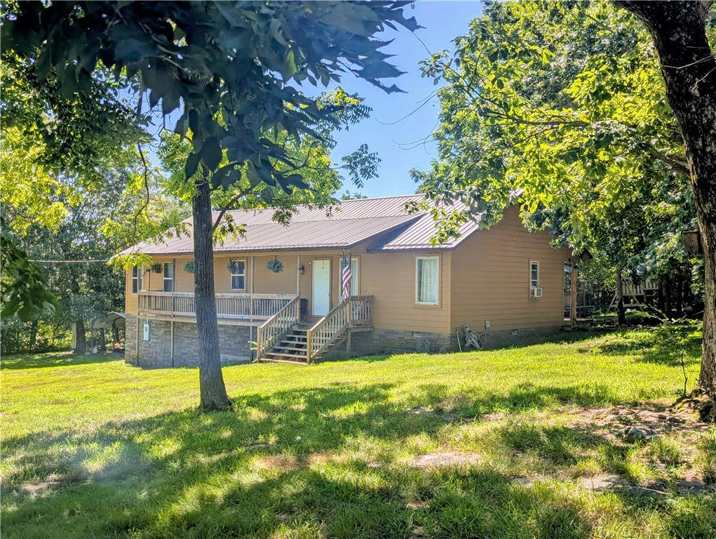Privacy & seclusion awaits with this 4 bedroom 2 bath home on 4.91 acres m/l built in 2008, as this home can't be seen from the road & another home can't be seen from it. There's plenty of rustic charm with this open floor plan, not to mention a large covered porch. Shipping container & storage building also convey with the property. All #s are approx, age & square footage per assessor.