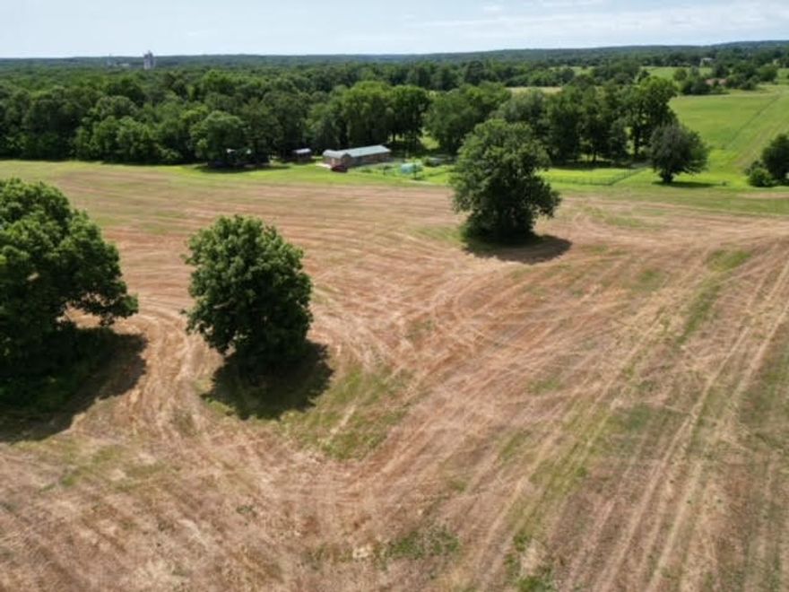 Introducing an exceptional opportunity to own 20 acres of peaceful countryside just outside the city limits, conveniently located near Northside Elementary School.  This stunning property features mostly open, level land that is partially fenced, offering ample space for your dreams, whether they include farming, gardening, hunting or simply enjoying the tranquility of rural living.  At the heart of this property is a charming 1624 sq ft home designed for comfort & convenience.  This inviting residence boats 2 spacious bedrooms & 2 1/2 baths, providing a cozy retreat for you & your family.  This home is fully electric, ensuring a modern living experience with efficient energy use.  In addition to the main residence, the property includes outbuildings, giving you additional storage opportunities or workshops.  With its generous land & ideal location, this property combines the best of rural life w/easy access to educational amenities & city conveniences.  Don't miss out on this incredible opportunity,