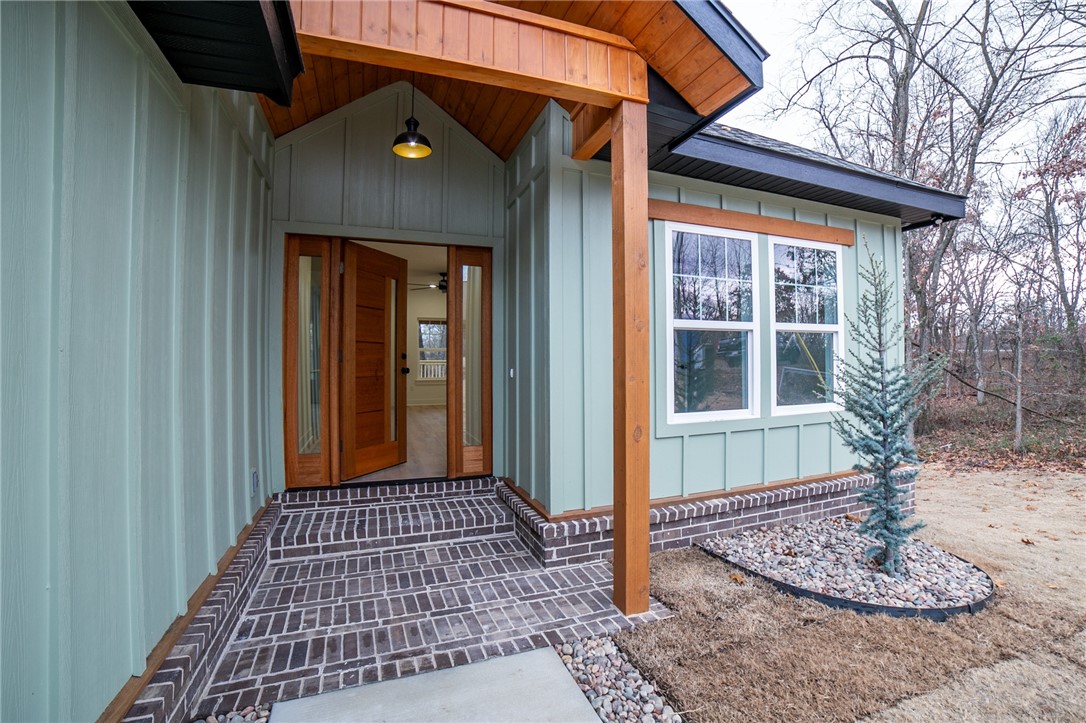 UPGRADES GALORE! Absolutely charming new construction home - ready for its first owner! Don't let the stunning exterior fool you... this home is way more than just a pretty face. 2x6 exterior walls, Ethernet to all rooms, EV charging in garage, propane range, on demand hot water, backup propane heating, and stunning interior finishes are major parts of this package! Luxury Vinyl Plank flooring in all living areas and bedrooms. Great storage above the garage and in crawl space. (entrance below the back deck.) Conveniently located near bike trails and Lake Windsor. Bentonville Schools. Washer and dryer convey with acceptable offer.