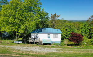 This cozy home is located on Highway 7 South, just 5 miles from Jasper. It has 2 bedrooms, 1 bath, and 744 sq ft of living space sits on .5 acres and has a full unfinished walkout basement. The home features a metal roof, hardwood floors, updated wiring, new lights, and new countertops. This property comes fully furnished and is ready to be your getaway, primary residence, or a nightly rental.