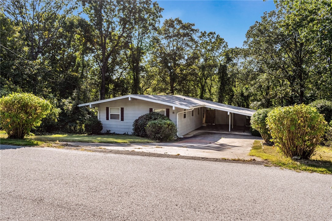 Walking distance to Lake Avalon pavilion and a short drive to the Tanyard Creek Nature Trail! Bentonville school district! This cozy home is located in a quiet neighborhood and features a wooded lot. Walking in you are greeted by an abundance of natural light from the large windows and cathedral ceilings! The eat-in kitchen boasts white cabinets with plenty of cabinet space, a large pantry, and beautiful view! Enjoy your morning coffee out on the back balcony and watch the wildlife! Below the balcony, you will find an additional storage space in the 9’ x 21’ workshop (not included in square footage) 2- car carport also offers additional storage. Updates include septic, deck, flooring, and roof.