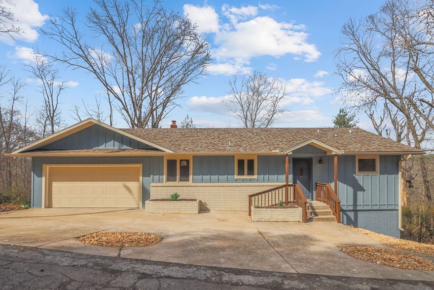 Tucked among the trees on Salen Lane, this fully updated 3-bed, 2.5-bath home offers privacy, modern finishes, and great value in Bella Vista. Inside you'll find new luxury vinyl plank flooring, freshly painted cabinets, granite countertops, stainless steel appliances, and fresh interior paint throughout. Both bathrooms have been fully remodeled with new tile floors, tiled stand-up showers, and new sinks and fixtures. The spacious upstairs living room includes a mini bar and built-in storage. The walkout basement has it's own exterior entrance to the backyard - ideal for guests or flexible living space and features a second living room, two bedrooms, and a full bathroom. Enjoy a rear deck overlooking the woods with no rear neighbors. A newer roof, graveled yard, and a matching storage shed complete the property. Bella Vista POA amenities include pools, tennis courts, trails, and scenic fishing lakes.