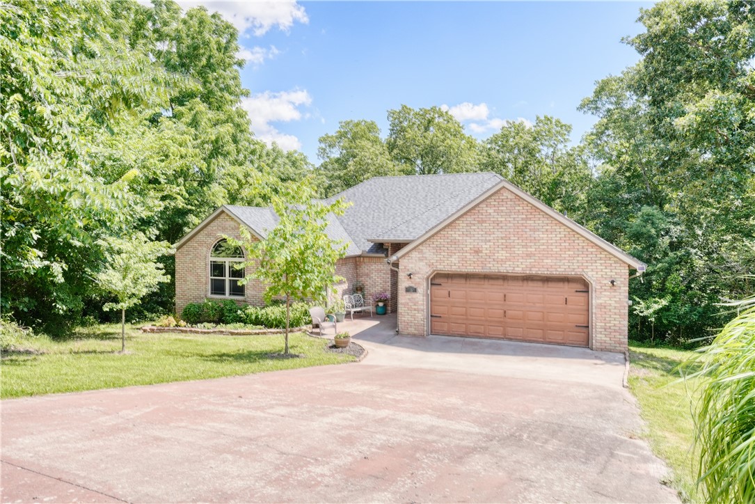 Fantastic location near MTB trails, the future OZ Trails Bike Park, & Lake Windsor. Located on a quiet cul-de-sac and backed by a common area, you will find this home offers privacy and serenity just 20 minutes from the Walmart HQ and DWTN Bentonville. You'll love setting on the freshly painted deck that overlooks the raised garden beds. Inside you will find spacious rooms and other features that include: crown molding, vaulted ceilings, updated lighting, a whole-home water purification system, Nest thermostat, and a stained concrete driveway. The full-height basement has plywood flooring, outlets, and attic access. New roof, gutters, and downspouts (2023), and hot water heater. The kitchen has all new appliances and a propane option for the dryer or range. Convenient access to Bentonville & Centerton via back roads. Bella Vista POA offers world class amenities that include: pools, tennis/pickleball, fitness centers, golf courses, a gun range, and access to lakes for kayaking and boating.