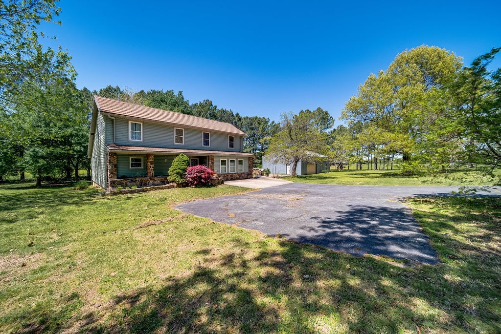 This is your home!!! This property is the home in the country setting with the land you have been waiting for! Park-like property with many mature trees and a beautiful row of pine trees which divide the 5 acres large enough for horses, a hobby farm, garden, or whatever you can dream up. Home has a metal roof that you will never have to worry to replace. Both of the heat pumps are recently new and have been serviced regularly. The water heater is brand new. With this two level home you will have plenty of room for your family to spread out and have their space. The master bedroom is on the main floor and you also have a wonderfully sized bonus room that can be anything your heart desires. You will love waking up and drinking your coffee in you screened back porch to take in your beautiful back yard. As if all these was not enough you will have a 1200 sq. ft. shop building to store all of the toys,
and work on all your projects! The freezer chest will convey. Make this one your heaven just minutes from town.