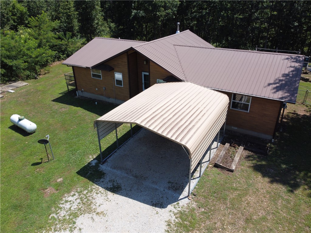 This 2 bedroom, 2 bathroom self sustainable home perfectly situated on just over 21 acres in the heart of Jasper, Arkansas. Tucked away in a quiet and peaceful setting near the Ozark National Forest, this property offers unmatched privacy surrounded by beautiful hardwood trees and abundant wildlife. The home is connected to the electric grid for convenience, yet thoughtfully equipped with a backup solar power system for energy independence. A rainwater catchment system with 5000 gallons of storage ensures a sustainable water source year-round. Make use of the existing gardens, chicken house, and be within steps of the Nation Forest for hunting.
Enjoy the best of both worlds—modern comforts in a secluded, nature-filled location. Whether you’re looking for a permanent residence, a weekend getaway, or a self-sufficient homestead, this property delivers peace, beauty, and practicality.