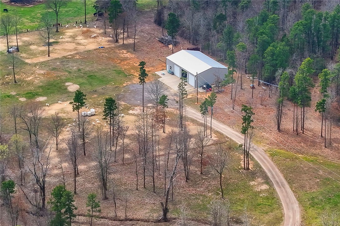 Peace, privacy, & panoramic views are found at this barndominium-type home w/2,400 sqft of combined living/shop space on 9.9 acres. 2 BR,1 BA, kitchen, living/dining areas provide creature comforts while putting dreams of land ownership to use. Or, comfortable home living quarters while enjoying seasonal RV travel or building a dream home on the property. Septic system designed for 3,000 sqft home provides options for expansion. A dehumidifier feeds the HVAC & keeps utility costs down. More well-lit storage/activity area above the living space. The shop has 3 large automatic overhead doors, is fully insulated with 14 ft walls, has electric & water, & 1 bay can handle a 2 post car lift. More parking/storage available on uncovered 12' x 40' concrete pad. Property has part of small pond, too. Pottsville school district & convenient to Russellville shopping / I-40.