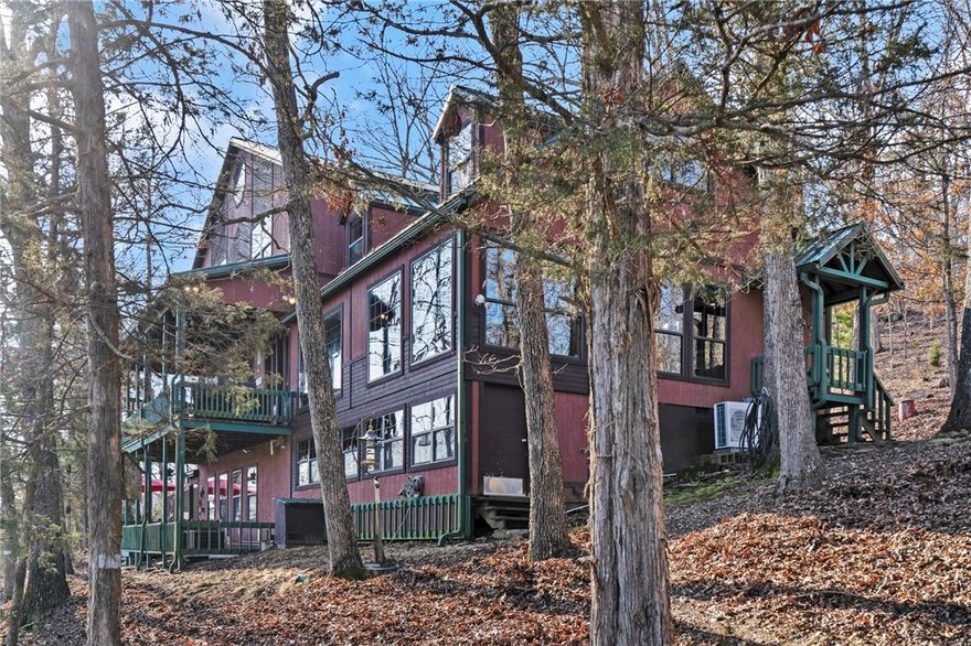 Looking for a peaceful, secluded escape from reality? Embrace that daydream at Emerald Pointe! Situated on 5+ acres w/~900 feet of shoreline, the home & land offer distinctive character, uniqueness & a canvas to create your own haven. Hickory floors, large windows, beamed ceilings, detailed woodwork, cathedral ceilings, built-in shelving/cabinetry, Generac generator, are some of the special features! Large, eat-in kitchen w/wood stove & sitting area. Formal dining room. 2 living areas, library/study, plus neat crow's nest loft/office! Spacious basement apartment ideal for in-law suite or vacation rental (no STR restrictions-covenants attached). Footpath right out the door to a private, single-slip boat dock w/swim platform. Boat, fish, swim to your heart's content, in the clear/deep water of Big Clifty Creek--home to famed Hogscald & Penitentiary Hollow! This cabin makes hosting groups of guests easy. Tell them to bring toys, too...there's a Corps launch at the end of Angell Rd. One of a kind home & worth a visit!