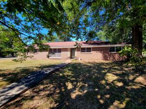 This 3-bedroom, 2-bath ranch-style brick home offers a fantastic opportunity for those looking to invest in a home with great potential. Situated on a large corner lot, this property is full of possibilities for renovation and customization to suit your personal style. This home offers a strong foundation, making it the perfect canvas for a homeowner ready to bring it back to life.Enjoy the convenience of being just a short walk away from local schools and churches, making it ideal for families or those who enjoy a close-knit community. The large yard offers plenty of space for gardening, outdoor activities, or even future expansion.Bonus is a 2-car carport and off of the carport is a laundry room and an office space that is heated and cooled.