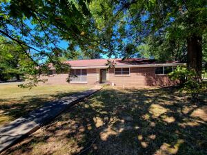 This 3-bedroom, 2-bath ranch-style brick home offers a fantastic opportunity for those looking to invest in a home with great potential. Situated on a large corner lot, this property is full of possibilities for renovation and customization to suit your personal style. This home offers a strong foundation, making it the perfect canvas for a homeowner ready to bring it back to life.Enjoy the convenience of being just a short walk away from local schools and churches, making it ideal for families or those who enjoy a close-knit community. The large yard offers plenty of space for gardening, outdoor activities, or even future expansion.Bonus is a 2-car carport and off of the carport is a laundry room and an office space that is heated and cooled.