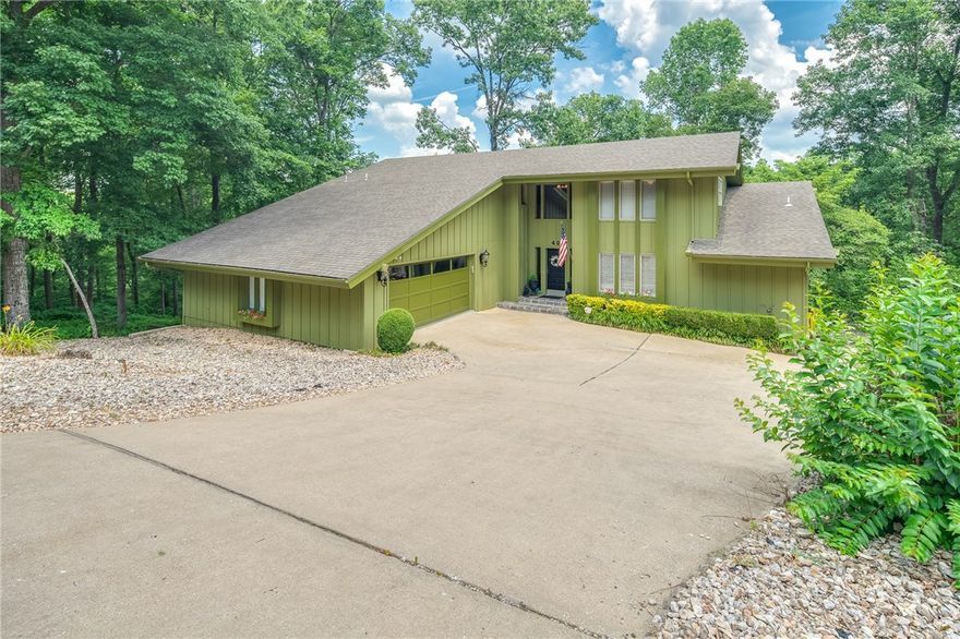 Prepare yourself to fall in love with this breathtaking contemporary custom design that is perfect for entertaining.  Multi level home offers 3763 s.f. of comfortable living plus a 220 s.f. sunroom to enjoy the picturesque views and a 829 s.f. of heated a cooled workshop/storage area for hobbies.  Stylish open concept boasts large rooms, soaring ceilings, bamboo flooring, spacious deck and patio with plenty of privacy.  Grand master suite suitable for royalty is located on the main level.  Media/family room in walkout basement with bar and theatre seating to convey.  Property has had many updates including exterior paint in 2019.  Walk to Branchwood Recreation area and enjoy hours of fun to include walking trails,  fitness center, tennis, indoor pool and locker room, 18-holes of disc golf and more.  Adjoining lot is available for purchase.  Come see what your money will buy!!!!