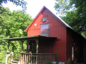 Endless possibilities and a great location fronting Hwy. 7 just south of the Jasper Square. Loft features a studio apt. or office. Could be used as a residence or commercial. 1.73 acres with hwy 7 frontage. Main part of building is an old carriage house that was moved from downtown Jasper. New additions.