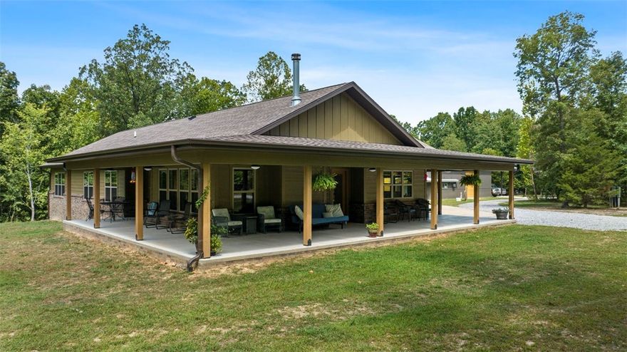 Beautiful wooded property situated on over 19 acres that boast a single-story farmhouse style home built towards the back of the property for privacy. Two master suites with custom bathroom showers and a 1474 sq ft wraparound porch with fans. There are views from every room in the house including the home office. It comes with a 1920 sq ft insulated workshop with three insulated overhead doors and an additional 960 sq ft of attached covered storage along with a shop office. There are two acres cross-fenced for animals and a 20' x 30' steel truss tractor shed. Built with energy efficiency in mind the home includes Argon filled low-e insulated windows, insulated garage, R38 ceiling insulation, and an EPA certified wood stove. The home has buried fiber and fixed wireless internet connections. There are several other spots on site for building and a pond at the entrance to the property. This property is a must see. Ask for the amenities sheet attached in the MLS. Located 20 minutes from Walmart Home Office.