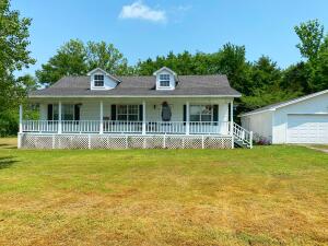 This adorable country home sits on 2 acres in Knoxville! The 1325 sqft house features a great floor plan with a cathedral ceiling in the living room, open kitchen and dining areas, 3 bedrooms and 2 bathrooms including a large master bath. There is also a large detached garage for storage or hobbies. This property has a very nice, level yard surrounded by trees and the lovely front porch has a nice view of a beautiful field.