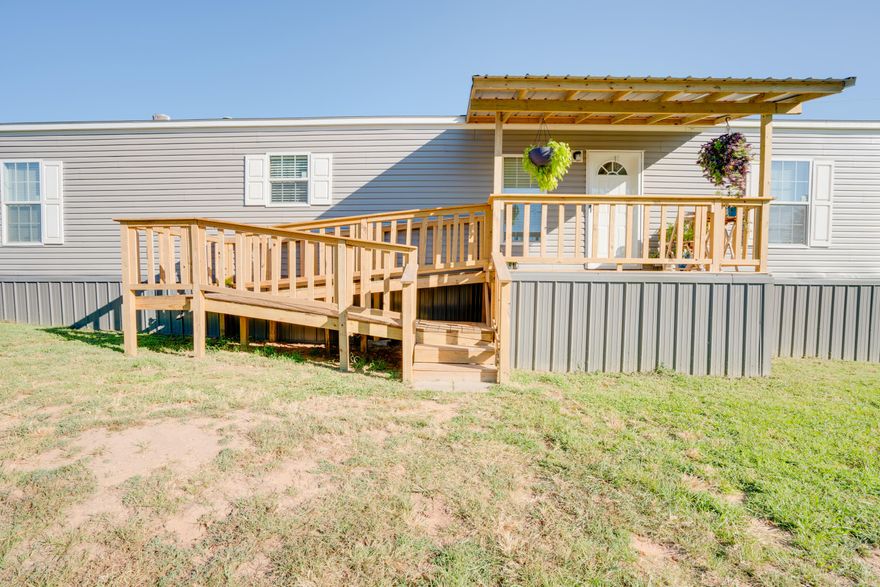 Escape to this 2021 modern mobile home with a permanent foundation, perfectly secluded on 8+/- acres in the natural beauty of Arkansas. Enjoy the privacy of a storage building, a newly constructed front porch, and a spacious back deck with a large cover for convenient car parking. RV enthusiasts will delight in the hookup with water and electric amenities. Step inside to discover a captivating interior, highlighted by a beautiful large kitchen island, an inviting eat-in kitchen, and a master bedroom boasting a walk-in closet, whirlpool tub, and walk-in shower. The practicality extends to a sizable laundry room, accompanied by two additional bedrooms and a well-appointed guest bath. This 1200sqft home is the epitome of comfort and convenience, offering everything you desire in a picturesque Arkansas setting!