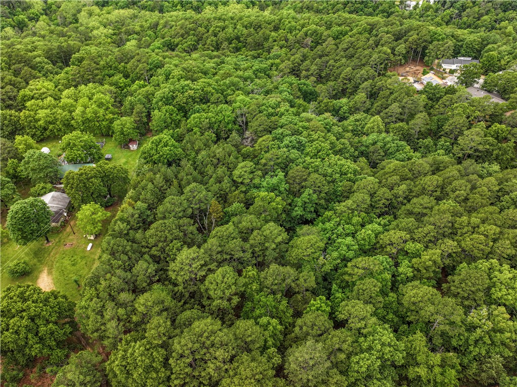 This buildable lot with an expansive view feels woodsy and remote, but is only a minute from Highway 62 in Eureka Springs, just inside city limits, convenient to restaurants and shopping: the best of both worlds! Septic and well will be required, but natural gas and Cox internet are available, as is Cox Cable Internet, with electric nearby. A trolley stop is at the corner of Hwy 62 and Thunder Road. Excellent for building your dream home or to hold as an investment. Nightly rental and home-based businesses are allowed.
This 2.83 acre parcel is also available to combine with adjacent lots for up to 5.51 acres total. See MLS #1276293. Owner financing available with a 25% down-payment.
