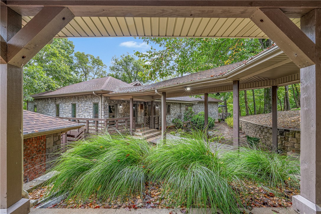 Set on a private and expansive lot, this Bentonville estate offers an exceptional balance of seclusion and convenience, located just minutes from downtown, the interstate, and the Walmart Home Office campus. The residence encompasses 6,957 square feet with 4 bedrooms and 4 bathrooms. Floor to ceiling windows invite natural light and capture treetop views that enhance the sense of retreat. A serene primary suite anchors the private quarters, while generous living areas and a hidden speakeasy provide both comfort and distinction. Beyond the main residence, the grounds feature a pool house appointed with a sauna, steam shower, and versatile space for fitness or relaxation. Designed to bring together privacy, natural beauty, and thoughtful amenities, this home reflects a lifestyle of elegance in the heart of Bentonville.