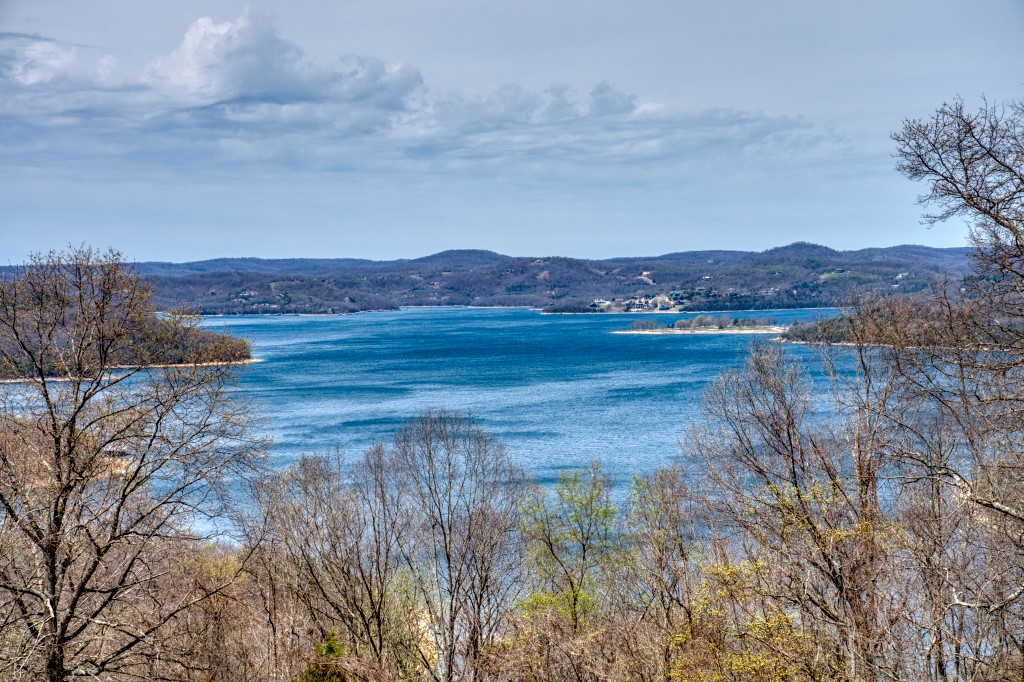 This gorgeous hilltop over looking Beaver Lake is a great place to build your home. The building site is almost flat for easier construction and the view is excellent! Highland Park Drive accesses this land and it also touches Mundell Road. These paved roads make access easy and electricity is at the street. This is a great location not far from Starkey Marina, Beaver Dam, and the White River, while still offering a quick drive into Eureka Springs! This 3.3 acres has low restrictions and also encompasses a gently sloped wooded area.