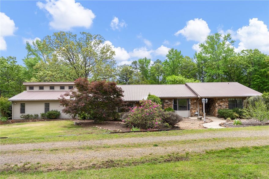 4 bed, 3 bath country home in Pope County, AR with 4,000+ sq ft — including a 925 sq ft finished basement — on +/- 4.52 acres near Atkins, just minutes from Russellville and I-40. Recently remodeled and move-in ready with granite countertops, hardwood floors, and a bright sunroom overlooking the backyard. Seller-owned solar panels reduce utility costs and a whole-home Generac Guardian generator ensures reliable backup power. Enjoy a large in-ground saltwater pool with a brand-new liner, access to a stocked fishing pond, and open acreage for recreation, gardening, or small livestock. Garage/shop and carport provide ample storage for equipment and hobbies. Is this home near Russellville? Yes — with quick and convenient I-40 access. Are the solar panels owned? Yes, full ownership transfers to the buyer at closing with no lease obligations. Is the pool move-in ready? Yes, featuring a brand-new liner. Hobby farm or private retreat potential? Absolutely — the acreage, stocked pond, and outbuildings make it possible.