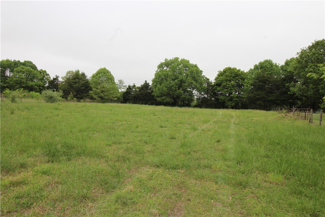 2 acres ready for you to build your home. Lots sold together are completely fenced and have water, electric, and septic on site on one of the lots. Has a nice shop building and several other buildings ready for your small farm. Rare find in NWA, lots are level from front to back.