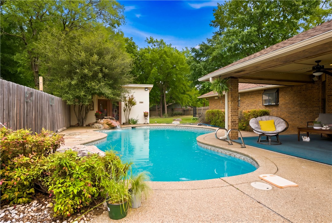 Freeform swimming pool featuring a waterfall, inte