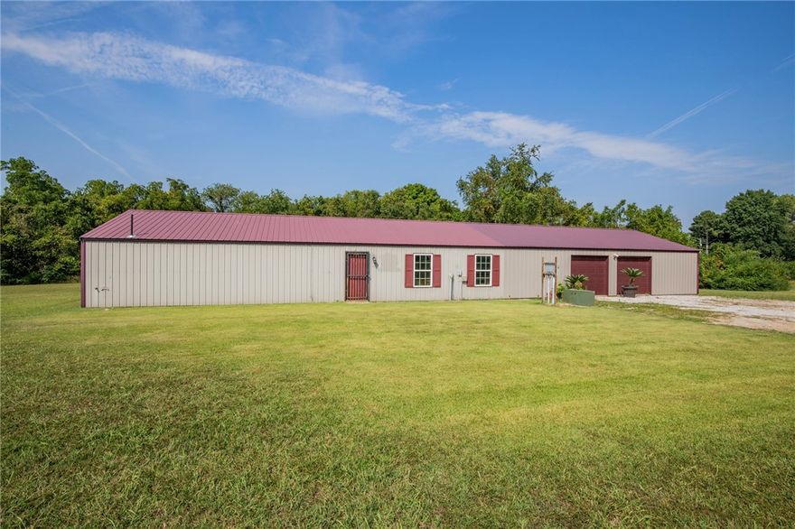 Exceptional 10-acre property with a 100’x30’ metal shop building. The land provides a mix of open and wooded areas, creating opportunities for both enjoyment and development. The large, insulated metal building includes a full bathroom and was once configured with a recording studio. It is ideal for business use, conversion to a barndominium/shop-house, or other creative purposes. The existing septic system is designed to serve a new 3-bedroom home and the shop building. This property has great potential: Build a new home and run your business out of the shop building, pursue larger-scale commercial or industrial development, an RV park or mini storage complex. It's just outside the Rogers city limits, on the north side of the Rogers City Airport, and near Hwy 62. Less than a 10-minute drive to downtown Rogers, or a 20-minute drive to downtown Bentonville. If you are seeking to build your dream home, looking for an investment property or a business opportunity, this is a rare offering in a great location.