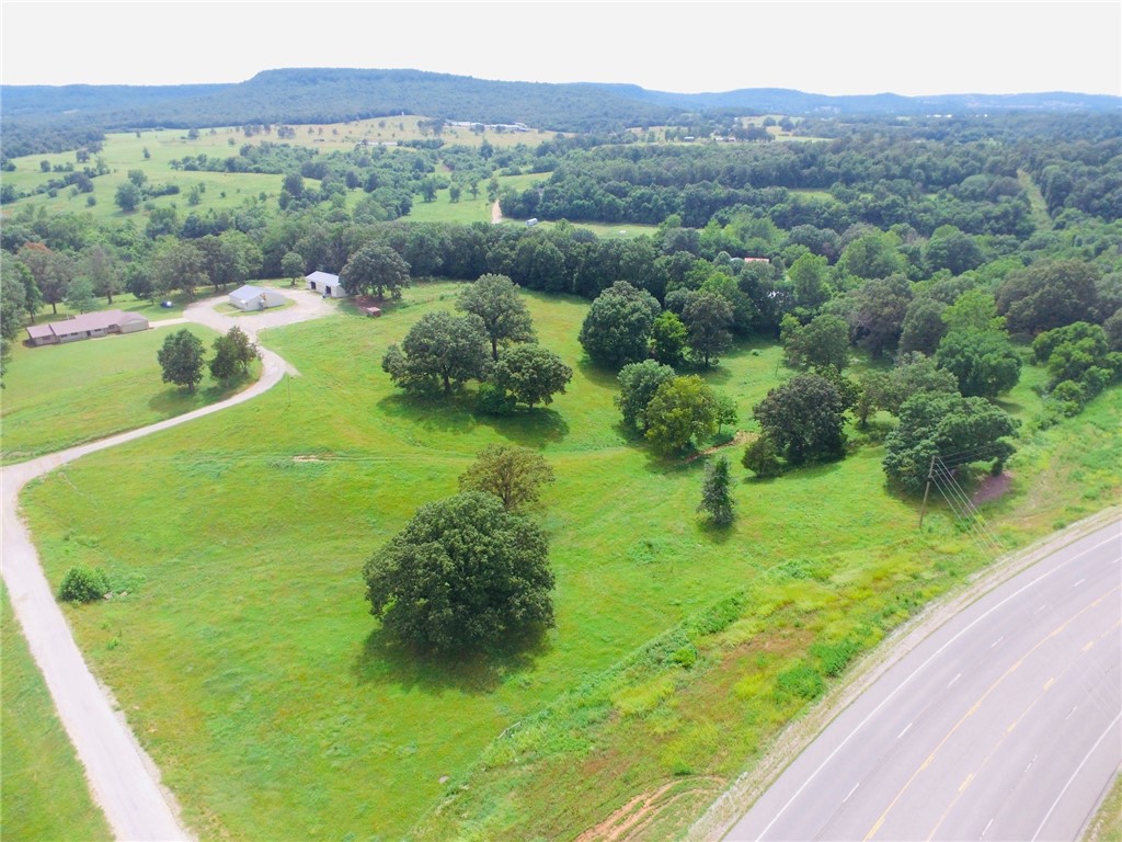 Spacious and well built home on 18 acres with 2 large outbuildings. Home is 4BR, 2.5BA with 2 car attached garage with opener, Formal Living and Dining areas, large family room, eat-in kitchen, large utility room, pantry, and a home office space. Shops both have power, one is insulated with 3 rooms and a bathroom plus shop area. The yard is a park like setting with views to the SW. Metal roof and brick exterior make for low maintenance. Hwy frontage but sets off the road nicely. Would work great for work at home or a small hobby farm. Close to Branson MO, Harrison AR, Table Rock Lake, Buffalo National River and Kings River.