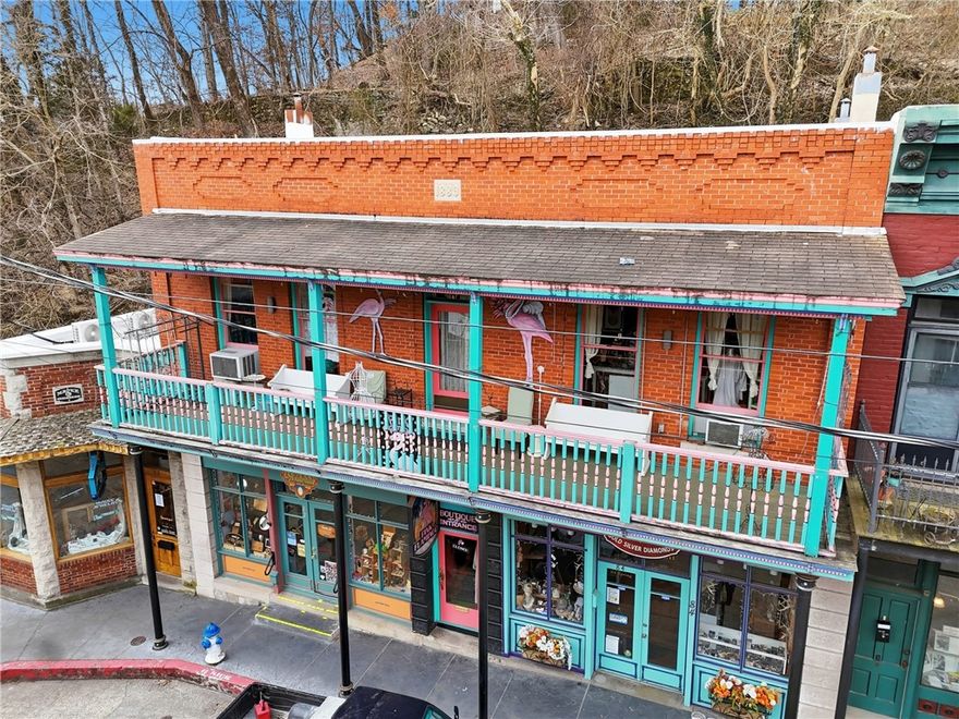Steeped in Eureka Springs history, this 1900-era top floor condo has been home to the beloved Pink Flamingo Boutique for more than 40 years, welcoming visitors with stylish women’s clothing and accessories. Featuring beautiful hardwood floors, 1,595 sq. ft. of space, and a covered porch, the property offers flexibility to suit a variety of uses. The layout allows for easy division of space, including the potential for owner’s quarters complete with a full bath and tub/shower. Zoned C-1 Commercial, the possibilities are wide open—whether retail, studio, office, nightly rental or a creative mixed-use setup. The entire second floor is yours to customize and make your own. The existing merchandise can convey to new ownership, but does not have to. A new roof installed in 2025 adds peace of mind and lasting value. Whether you continue its legacy or start a new chapter, this timeless property is ready to inspire your next venture.
