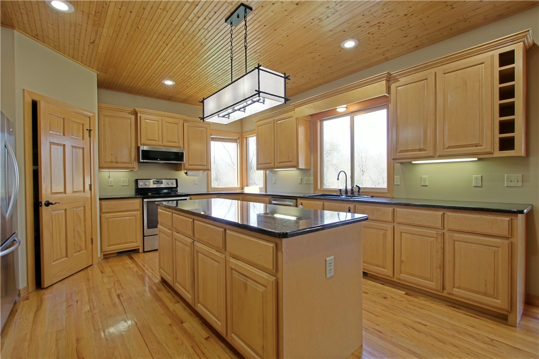 Price improvement! Welcome home to country living right in the middle of everything! Huge shop with acreage, these rarely come up in town. This spacious home located just yards outside city limits but close to all the amenities of Bentonville. 8 min to the square. Enjoy the view of the trees from the huge covered back deck! Brand new roof and gutters 2022, whole house generator with auto start for emergencies, newer main level hvac, Exterior has been extensively updated with fully paved driveway, landscape block raised garden with planters, fresh exterior paint. Wake up in the spacious master suite overlooking the private wooded back yard. The expansive eat in kitchen is perfect for family gatherings, flows into the hearth area with a gorgeous plank wood ceiling. Two sided wood burning fireplace for cold nights. Front yard is massive, plenty of space to feel like you are miles away from your neighbors. Tons of storage, ample closet space, solid oak floors, and lots of windows to take in the private views.
