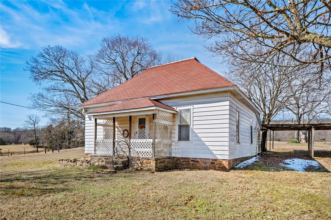 Cute country home on 33.46 acres just outside of West Fork on the west side of I-49. 2 bed, 1 bath with walk-in shower and sit down vanity. Generous kitchen with double built-in double oven and countertop cook top. Eat in kitchen. The land has 2 nice size ponds and is fenced on 3 sides. There is a barn, 2 sheds and a well house along with a corral. All appliances convey with the house. There are deed restrictions with no mobiles or chicken houses allowed. House being sold AS-IS. House is a fixer upper and will not go secondary market on lending. Please close gates due to livestock on property.