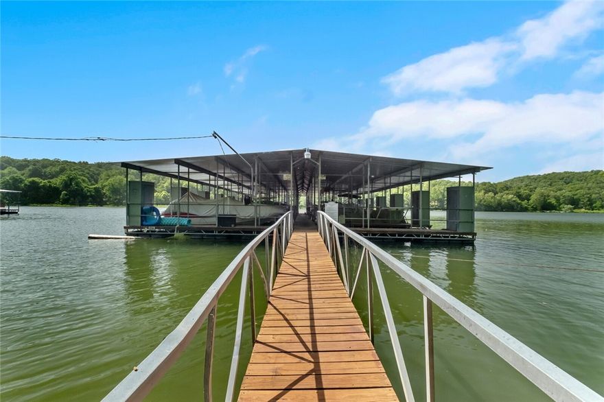 You will love the peaceful park like setting of this 3 acre Lake Lodge with boat slip in community dock. Flowing floorplan with main level master. Abundant outdoor living spaces perfect for entertaining. Recently remodeled with new flooring, new granite, new appliances and so much more. You will love watching nature come alive from the back deck or relaxing on the patio terrace. Upstairs bedrooms with j&j bath, lower level with office, large living with wet bar. Easy access to downtown Rogers. Get ready to love the summer and lake living.