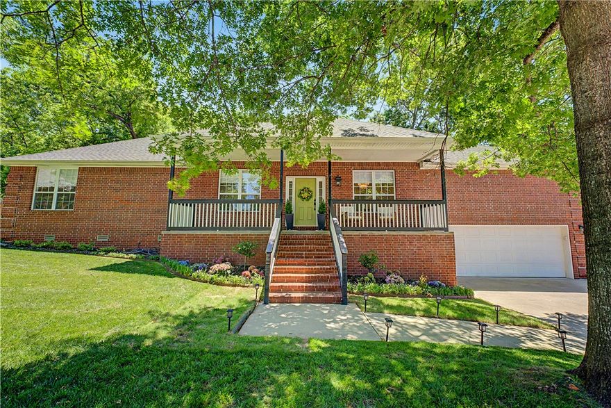 Everything you are looking for. Spectacular 4 bdrm home sits at end of cul-de-sac with easy access to I-49, hospital, shopping, direct access to Razorback Greenway, private bedroom with en suite bath or great office/exercise room.  Create your own personal oasis on a 45x15 deck with pergola overlooking a parklike backyard with mature trees and view of golf course and lake. Freshly painted walls and cabinets throughout. Whole house hot water heater and recirculation pump 2023, new ceiling fans 2026, carpet and laminate flooring 2022, custom fitted shades 2023 and 2026, new counter tops in kitchen, and hot tub hookup. The garage has a large storage area.