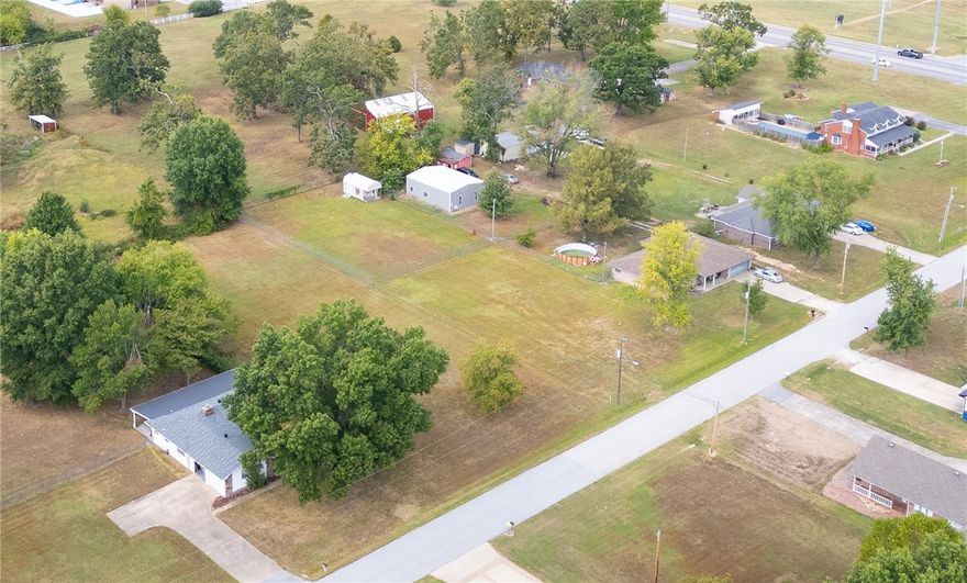 Large lot (.65 acre). This is a great location to build a wonderful home in an established neighborhood within Bentonville city limits. Lot is level and cleared; perfect to add a swimming pool or shop building. A 5' high chain link fence with a double gate encloses the back portion of the lot. The chain link fence is 90' wide and 126' deep. The lot is 90' wide and 304' deep.  The storage building conveys (12'x12').  No POA dues.  Close to Bentonville amenities, yet located in a peaceful and pleasant neighborhood with no drive-through traffic. There is only one street in the neighborhood and it dead-ends into a culdesac. The homes are attractive and well-kept on large lots with mature trees.  Just minutes from trails, Osage Park, the coming-soon 8th Street Gateway Park, new Walmart Campus, Downtown Bentonville, Highway 102, Walton Blvd, I-49, shopping, restaurants, business centers, fitness centers, medical facilities. Bentonville Schools.