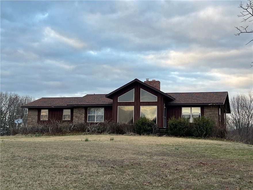 Ozark Mountain Views with a 3,014 SQFT home on 80 acres with 20 acres of prime hay-field pasture!! This 4BR-3BA home features a newly updated full basement, floor-to-ceiling living room windows, beautiful brick fireplace with wood stove insert, spacious screened in porch, efficiently designed galley kitchen, cathedral ceilings, walk-in closets, and wood stove in the basement.  The 80 acres features 2 fenced pasture areas, two ponds in the woods, and a large machine shed. Deer, bear, turkey, and elk have been seen on the property. Excellent hunting, seasonal creek, rolling topography, private location, and all home appliances and gun safe convey. Approximately 25 minutes into Harrison.