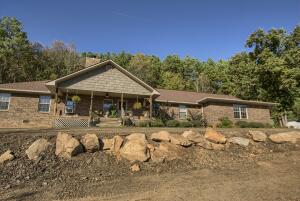 Enjoy views of Lake Dardanelle and Mount Nebo from your front porch! A wood-burning fireplace, real wood flooring, and cathedral ceilings make the heart of the home feel very open and inviting. The large master suite has an attached walk-in closet, a full bath with walk-in shower & soaker tub, and extra office space off the bedroom. The kitchen features granite countertops and plenty of storage with a walk-in pantry. An attached two-car garage, and a detached shop/garage allow plenty of storage for toys and tools. The Mother-in-Law wing can be finished out to your specs with a full bath and small kitchen area. When family gathers, there is plenty of space to relax on the front porch, or the covered patio. With propane storage, and a Generac generator, you will never be without power.