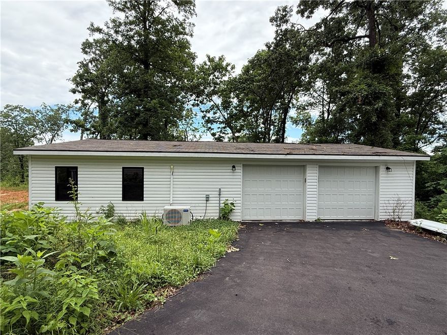 2.78 acres with much potential, Lot has preexisting well 765 foot deep with steel casing, 500 gallon septic tank, 1500 sq ft finished building to include mini split unit,  half bath on one side and 2 bay garage with keyless entry on the other This could be turned into a great tiny home. Asphalt driveway into property.  Very private.Cox cable available.ADT