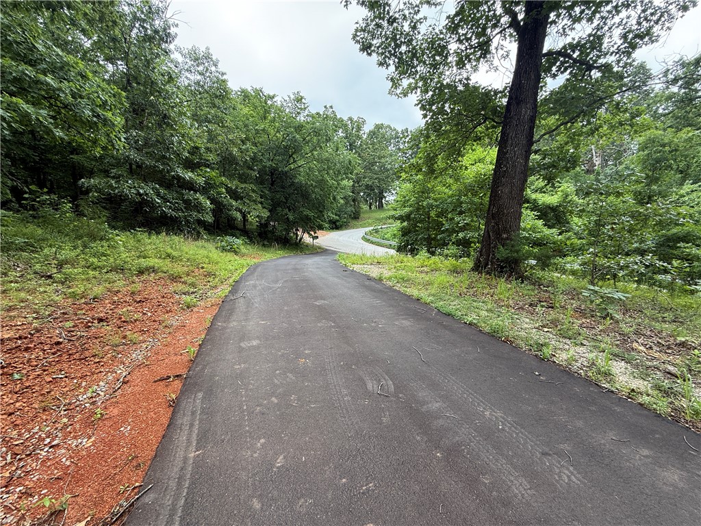 2.78 acres with much potential, Lot has preexisting well 765 foot deep with steel casing, 500 gallon septic tank, 1500 sq ft finished building to include mini split unit, half bath on one side and 2 bay garage with keyless entry on the other This could be turned into a great tiny home. Asphalt driveway into property. Very private.Cox cable available.ADT