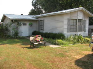 MINI FARM.....is what you will get with this 4 acre, fenced, pond, & barn. The home features a 3 bdr, 2 bth, 2 living areas, updated kitchen & bathrooms, metal roof, large country porch on front & back, carport, storm shelter, and close to town.