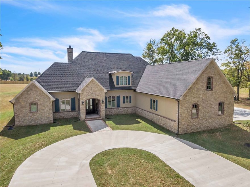 Nestled on 6 acres of serene woodland, this exquisite 4,982 square foot French Country estate offers the perfect blend of luxury & tranquility.
Expansive Living Spaces: Enjoy soaring cathedral ceilings, a sun-drenched sunroom, and a spacious bonus room over the garage, ideal for a 4th bedroom, home office or entertainment area.
The centerpiece of the home is a stunning, wood burning, 24-foot rock fireplace, creating a warm and inviting atmosphere.
Luxurious Master Suite: Retreat to your private sanctuary with a master bedroom featuring ample closet space and a spa-like en-suite bathroom.
Upstairs Suite: Upstairs is a large, modern suite with a private bathroom, quartz countertops, walk-in closet, and a laundry chute.
Outdoor Paradise: Step outside to your own private oasis, with a picturesque field view, refreshing saltwater swimming pool, and mature trees providing a peaceful, secluded setting.