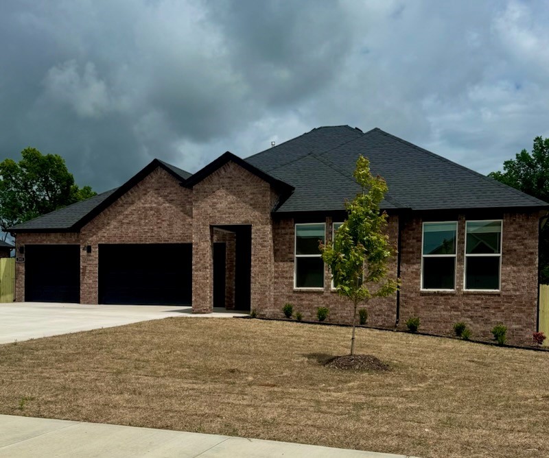Delightful Dean plan with a 3-car garage in Hillcrest, where you'll experience modern luxury living in the heart of Siloam Springs, Arkansas. Meticulously crafted floor plans providing ample space for you to grow and thrive. you'll find your perfect home here. Bedroom 1 will have a fan and your fabulous en suite will have an oversized walk-in shower, elongated commode, quartz counters. Fantastic quartz counter tops also in the kitchen with tile backsplash and 42-inch upper cabinets. Black plumbing fixtures throughout! LED lighting throughout! Living room will have a fan and a modern electric fireplace with a poplar mantle.